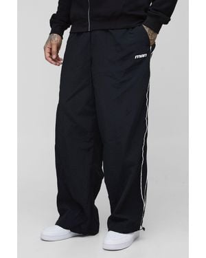BoohooMAN Tall Stripe Embroidered Parachute Pants - Black