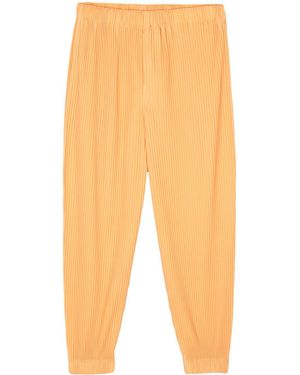 Homme Plissé Issey Miyake Plissé Tapered Trousers - Orange