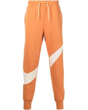 Nike Swoosh-Print Fleece Track Trousers - Orange