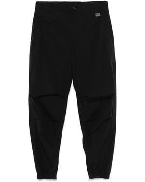 Dolce & Gabbana Tapered Trousers With Logo Plaque - Black