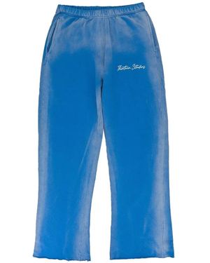 THIRTEENTH STUDIO Faded Logo-Print Track Trousers - Blue