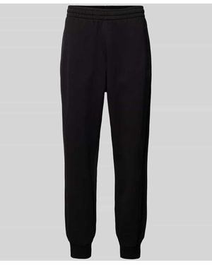 EA7 Relaxed Fit Sweatpants mit Label-Print Modell 'TRAIN VISIBILTY' - Schwarz