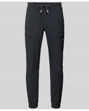 Fabletics Slim Fit Sweatpants mit Logo-Print - Schwarz