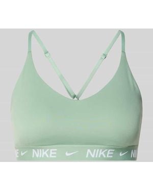 Nike Slim Fit Sport-BH mit Logo-Print Modell 'Indy' - Grün