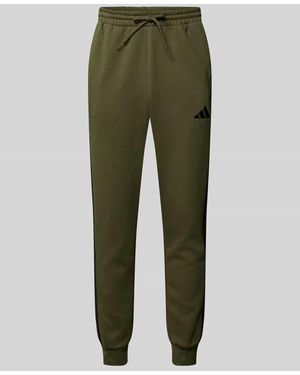 adidas Sweatpants mit elastischem Bund und Label-Stitching - Grün