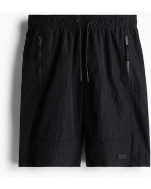 H&M Lange wasserabweisende Sport-Shorts - Schwarz
