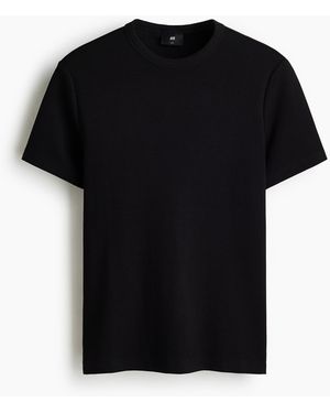 H&M Geripptes T-Shirt in Slim Fit - Schwarz