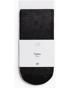 H&M Glitzernde Strumpfhose aus Plumetis - Schwarz