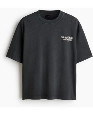 H&M Bedrucktes T-Shirt aus Baumwolle in Oversized Fit - Schwarz