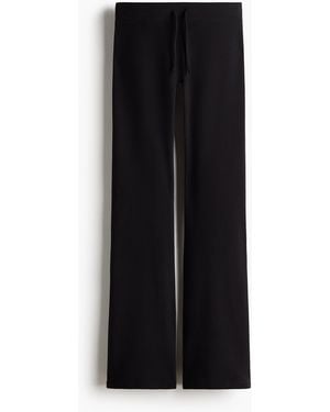H&M Ausgestellte Yoga-Joggpants mit SoftMove - Schwarz