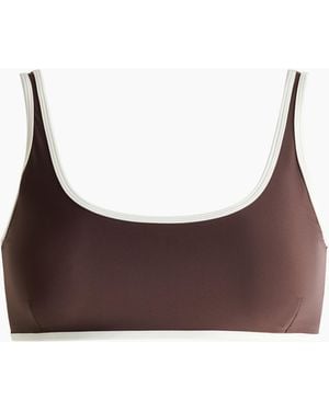 H&M Sportbikinitop - Bruin