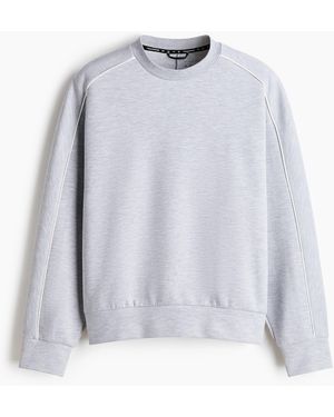 H&M Sport-Sweatshirt mit DryMove in Oversized Fit - Weiß
