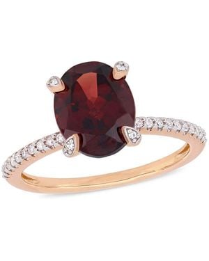Amour 3 Ct Tgw Oval-Cut Garnet And 1/10 Ct Tw Diamond Ring - Red