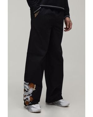 BoohooMAN Tall Baggy Fit Dragon Embroidery Elasticated Trousers - Black