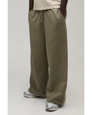 BoohooMAN Extreme Wide Leg Exposed Seam Toggle Hem Jogger - Green