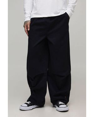 BoohooMAN Tall Elasticated Waist Oversized Hem Popper Trousers - Black