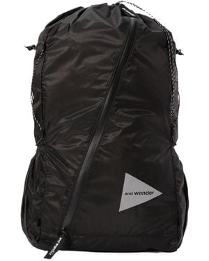and wander 111 Logo Detail Sil Backpack - Black