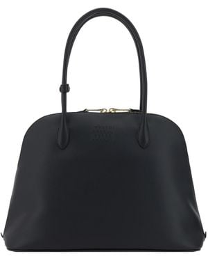Miu Miu Logo-Embossed Zipped Handbag in Black | Lyst