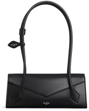 Alaïa Borsa piccola le teckel flap in pelle di capra lucida - Nero