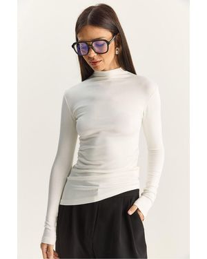 Bianco Lucci Fitted Turtleneck Long Sleeve Blouse With Ruffle Detail - White