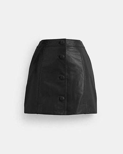 COACH Minifalda de charol - Negro