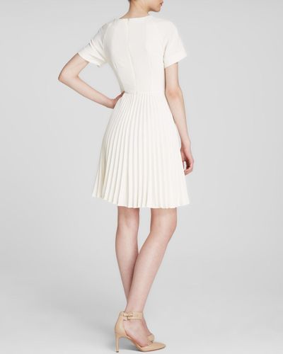 white dress with pleated skirt