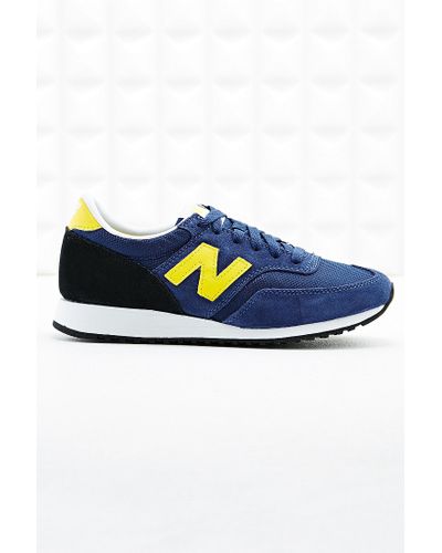new balance 620 runner trainers in navy and yellow