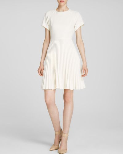 white dress with pleated skirt