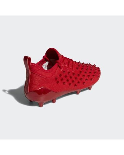 red spike adidas cleats