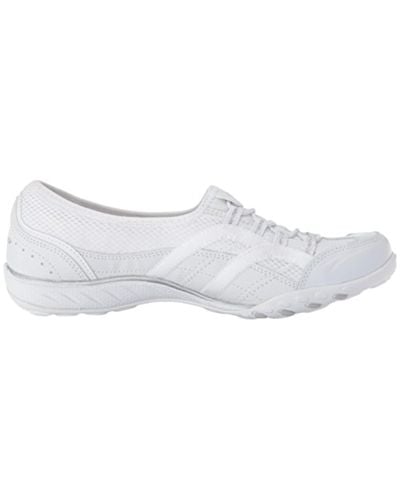 white skechers slip on trainers