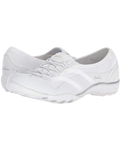 white skechers slip on trainers