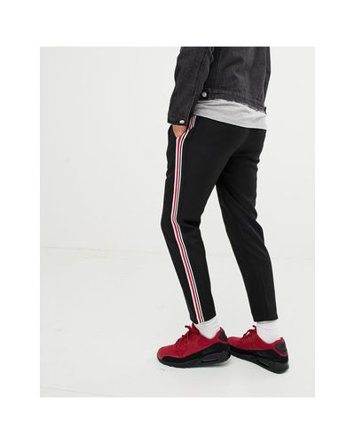 Pantaloni neri con riga laterale rossa e biancaPull\u0026Bear in Denim da Uomo  colore Nero | Lyst