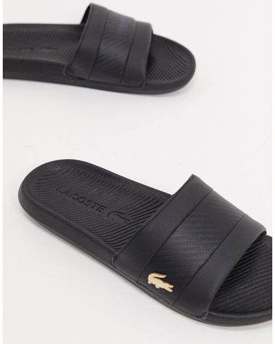 Sandalias negras con cocodrilo dorado Lacoste de hombre | Lyst
