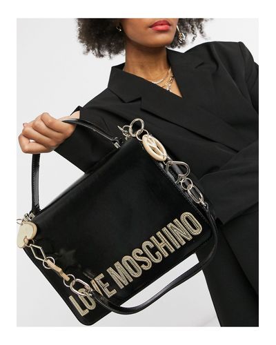 Borsa da spalla nera con simboli pace e amore e stelle di Love Moschino in  Nero | Lyst