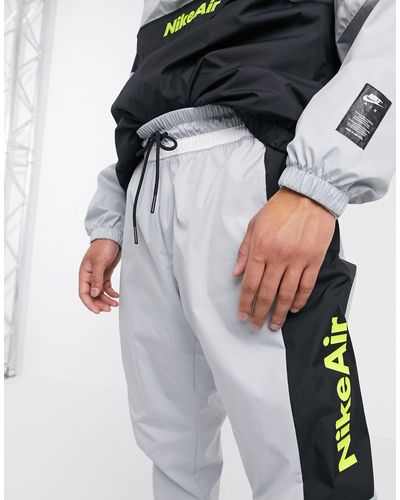 nike heritage essentials windrunner cuffed woven joggers in black
