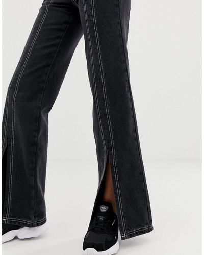 Jeans a zampa lunghi con spacco sul davanti e cuciture nere e bianche a  contrastoASOS in Denim di colore Nero | Lyst
