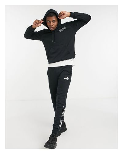 PUMA Amplified Arm Tape Logo Hoodie in Black for Men - Lyst