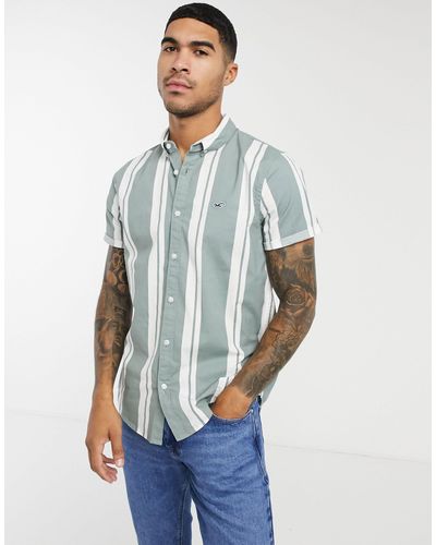 Camisa slim en color verde/blanco a rayas con logo icónico Hollister de  hombre de color Verde | Lyst