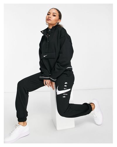 nike mini swoosh oversized trackies in black
