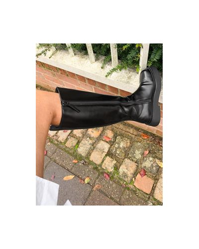 asos design christa flatform knee boots in black patent
