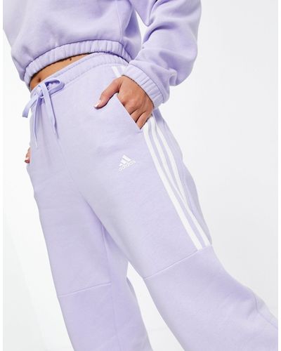 white and purple adidas tracksuit