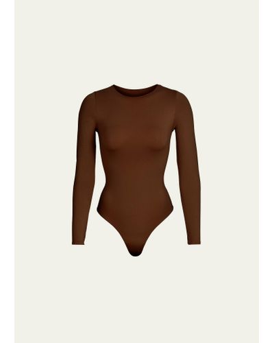Skims Essential Smoothing Long-sleeve Thong Bodysuit - Natural
