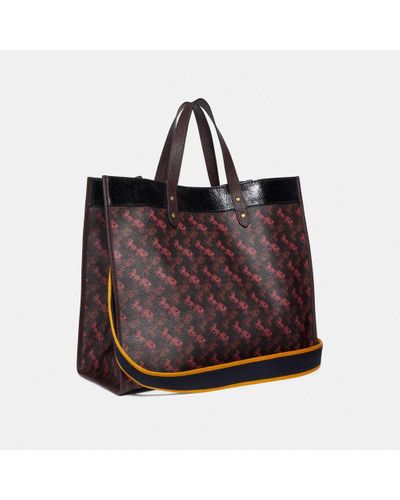 coach field tote 40 with horse and carriage print and varsity stripe
