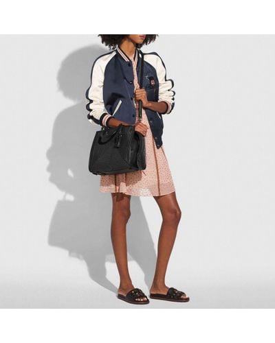 coach rogue with quilting and rivets