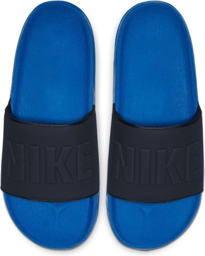 blue and yellow nike slides