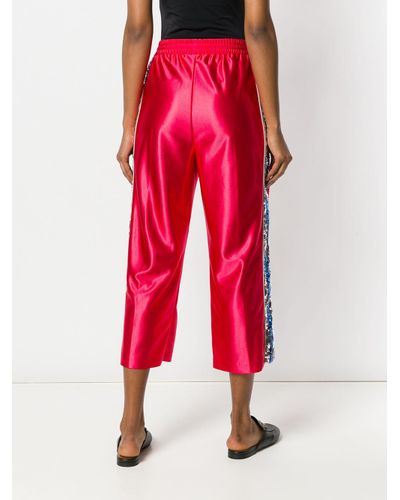 Gucci Pantaloni della tuta con banda laterale con lustrini da donna di  colore rosso