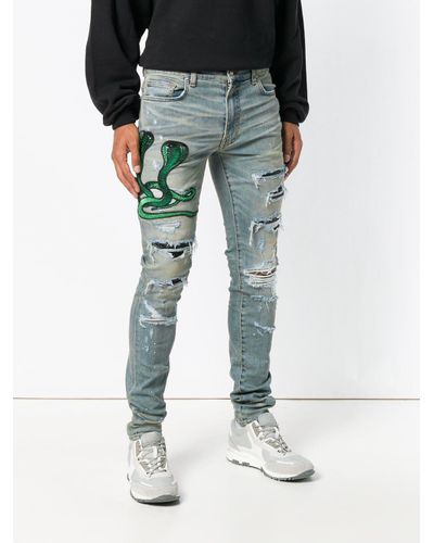Jeans con strappi decorativi con applicazione serpenteAmiri in Denim da  Uomo colore Blu | Lyst