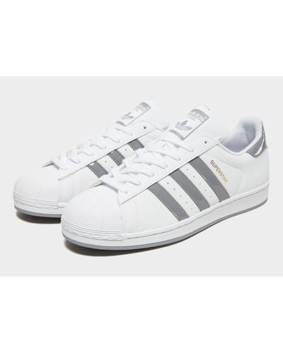 grey superstars with white stripes