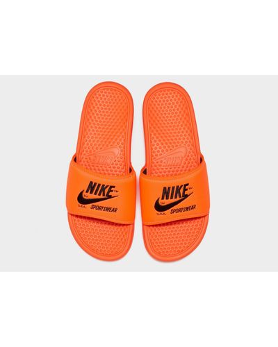orange nike sliders