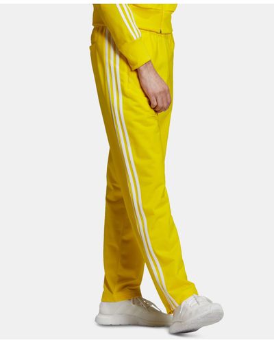 black and yellow adidas track pants